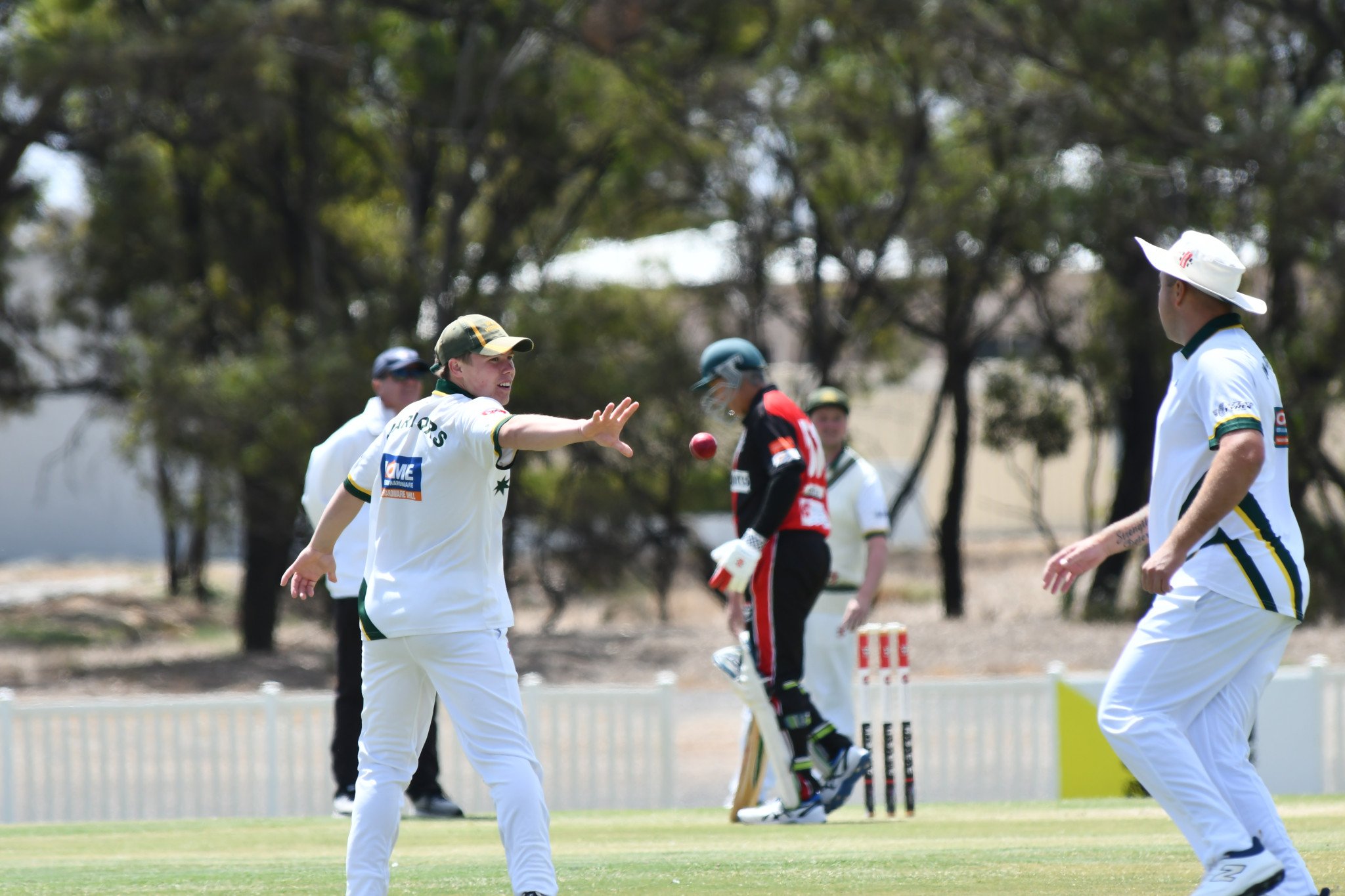Warriors' Jobe Dickinson passes the ball off to a teammate after fielding the ball. PHOTO: CHRIS GRAETZ
