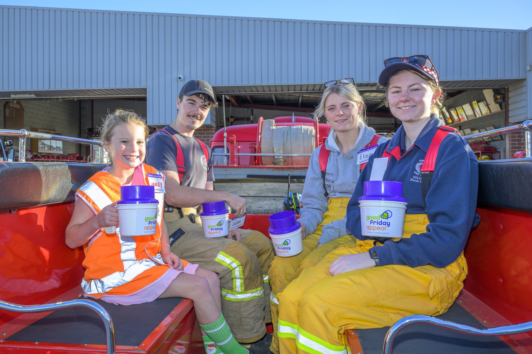 Macey Smith, Callum Taylor, Eliza Phillips and Georgia Walsh preparing to head out on the back of the vintage fire truck.