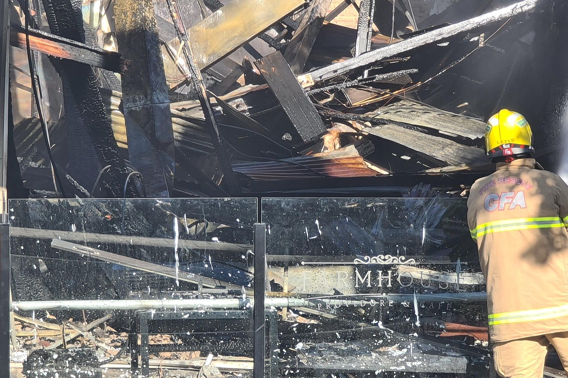 CFA personnel look into the devastating space that was the Farmhouse Cafe' before fire tore through it Wednesday morning October 9. Picture by Sheryl Lowe