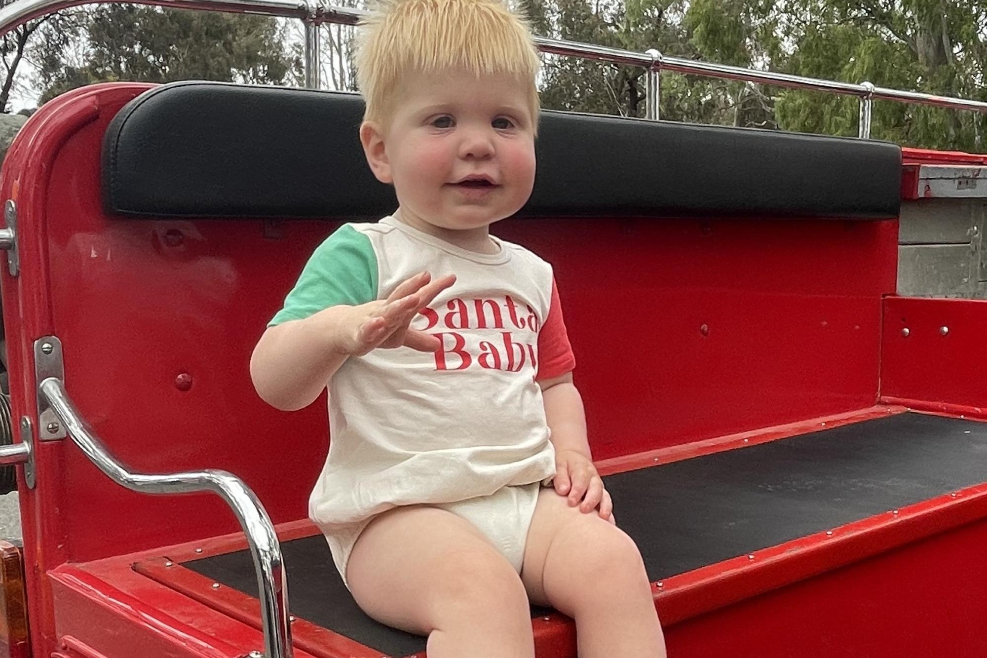 Fourteen-month-old Angus Hopper was sporting a Santa Baby shirt and was keen to climb aboard the fire truck at the HRCC Summer Series event. Picture by Sheryl Lowe