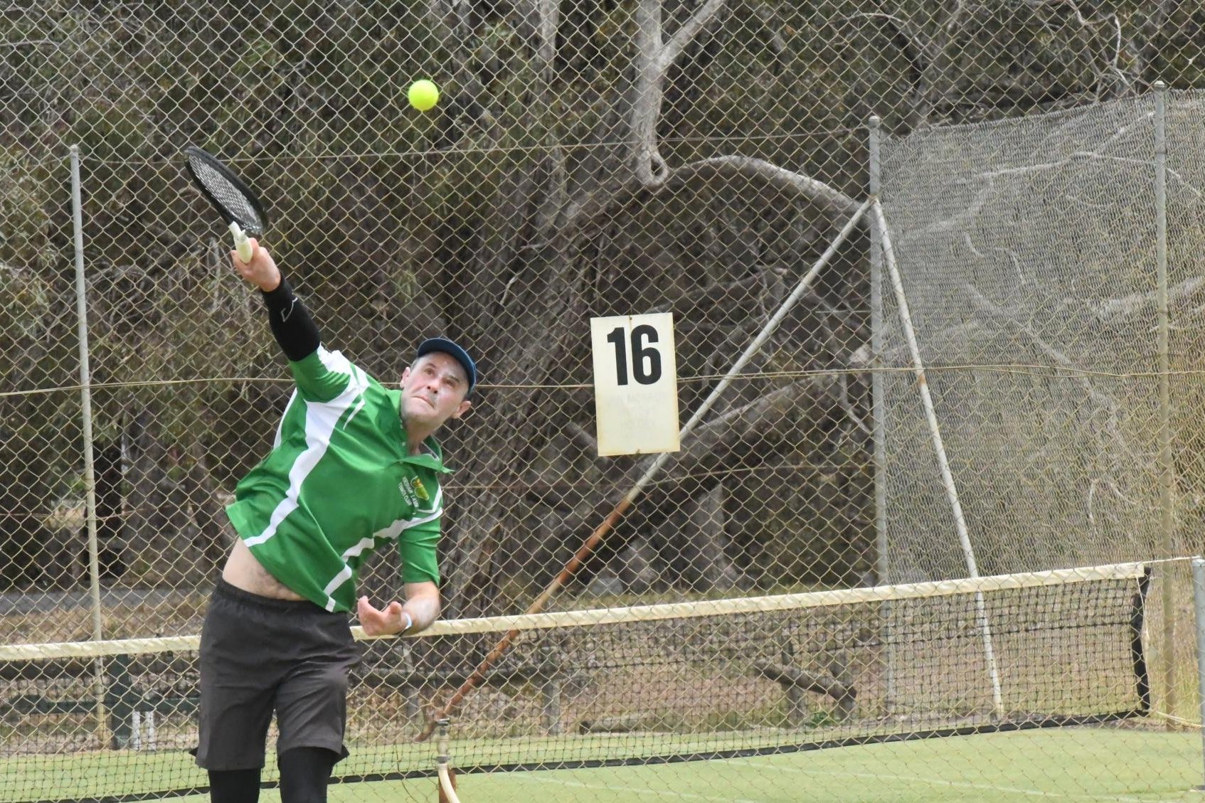 Horsham Lawn's Sam Hoffman strikes a serve against Drung South. Picture by John Hall