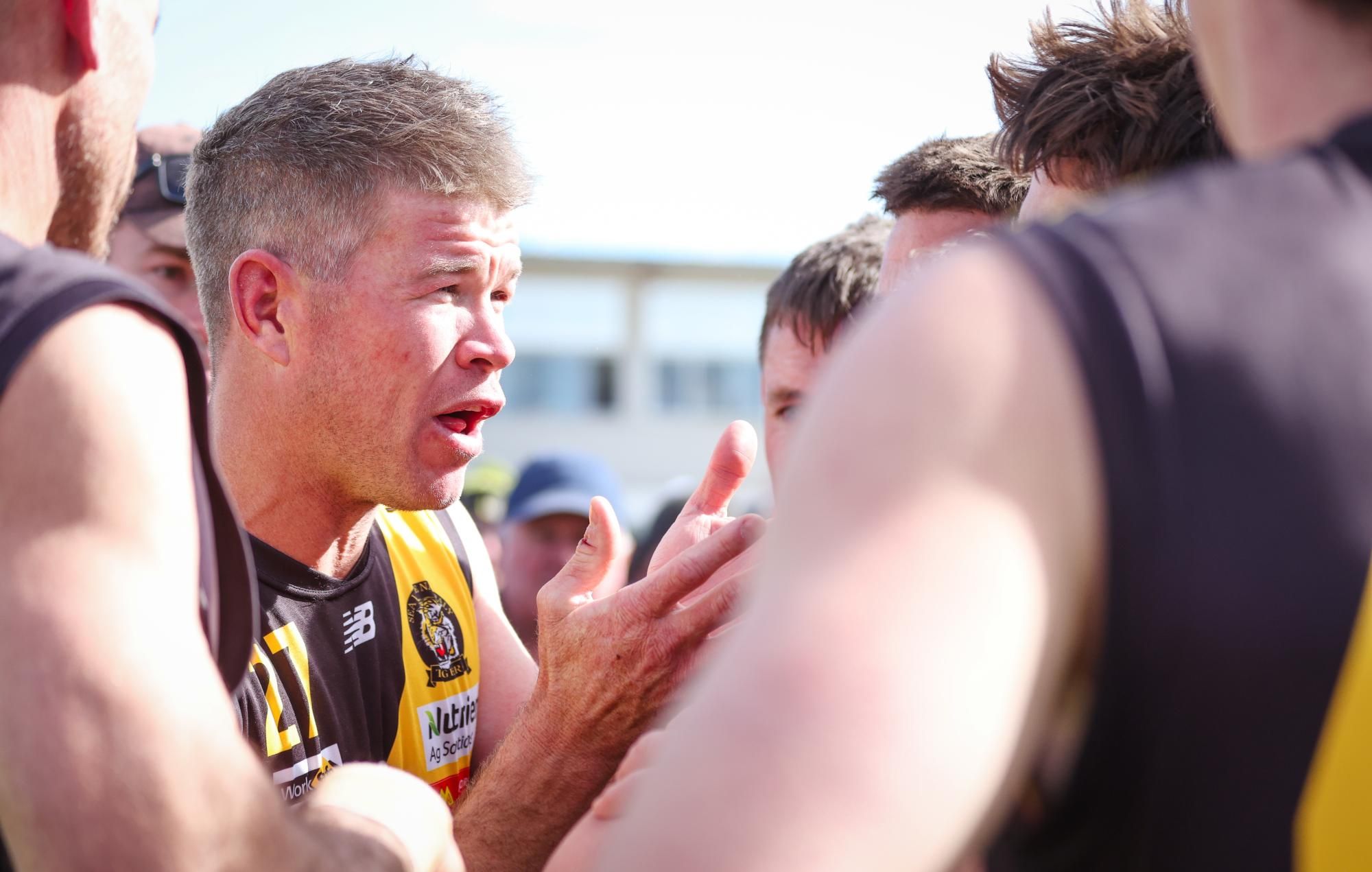 Tigers coach Bryce Delmenico adressing his team at quarter time. Picture by Blake Lee