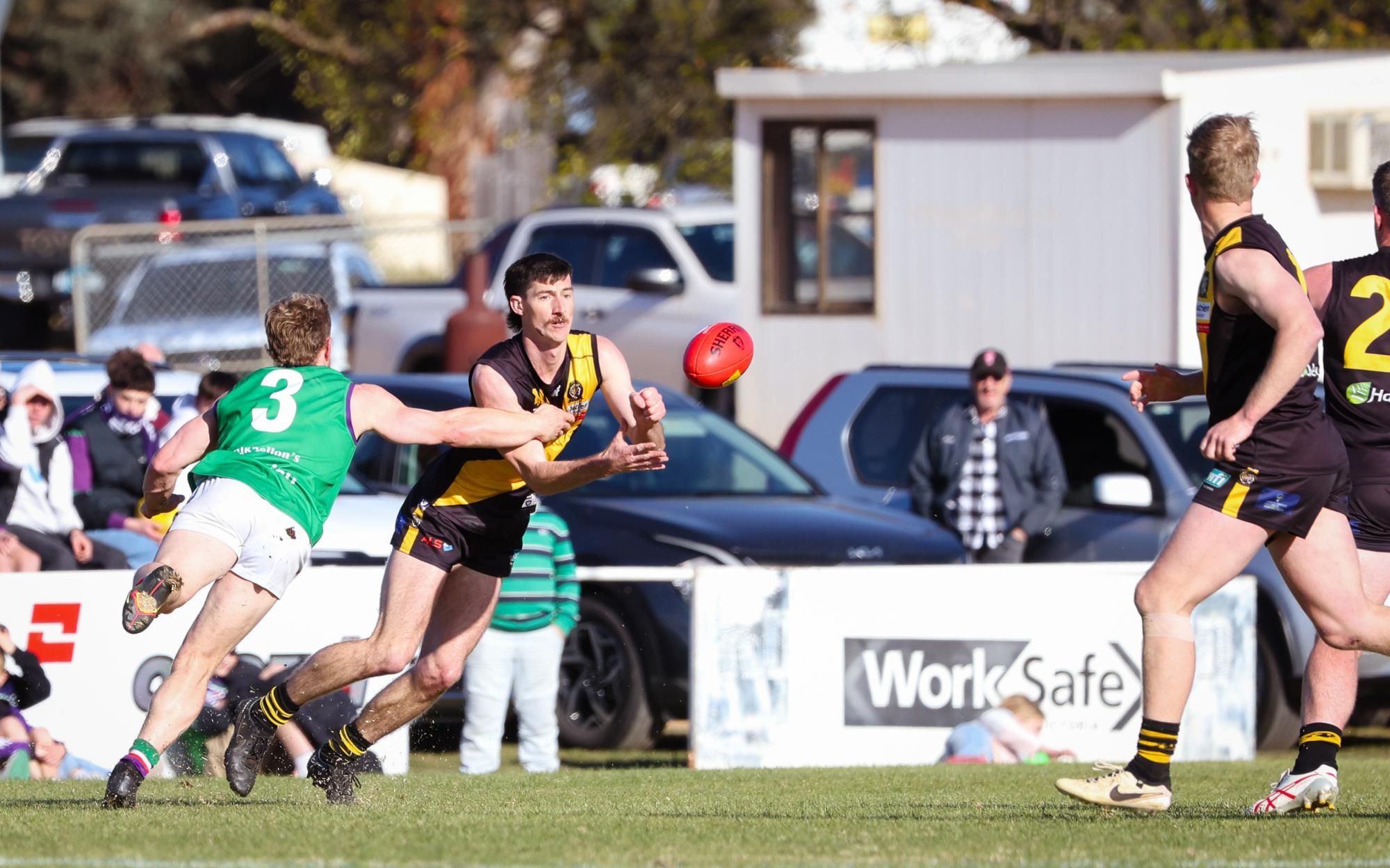 Jack Poulton, awarded Best on Ground, gets the hands out under pressure from Nicholas Rippon. Picture by Blake Lee