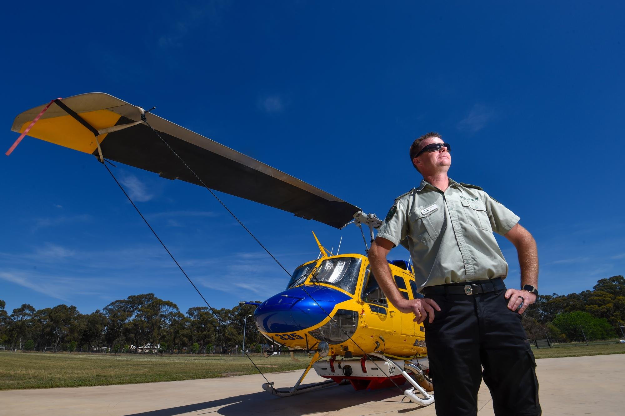 Braden Pearce, the senior emergency preparedness manager officer the Murray Goldfields District in front of Helitak 335. Picture by Darren Howe