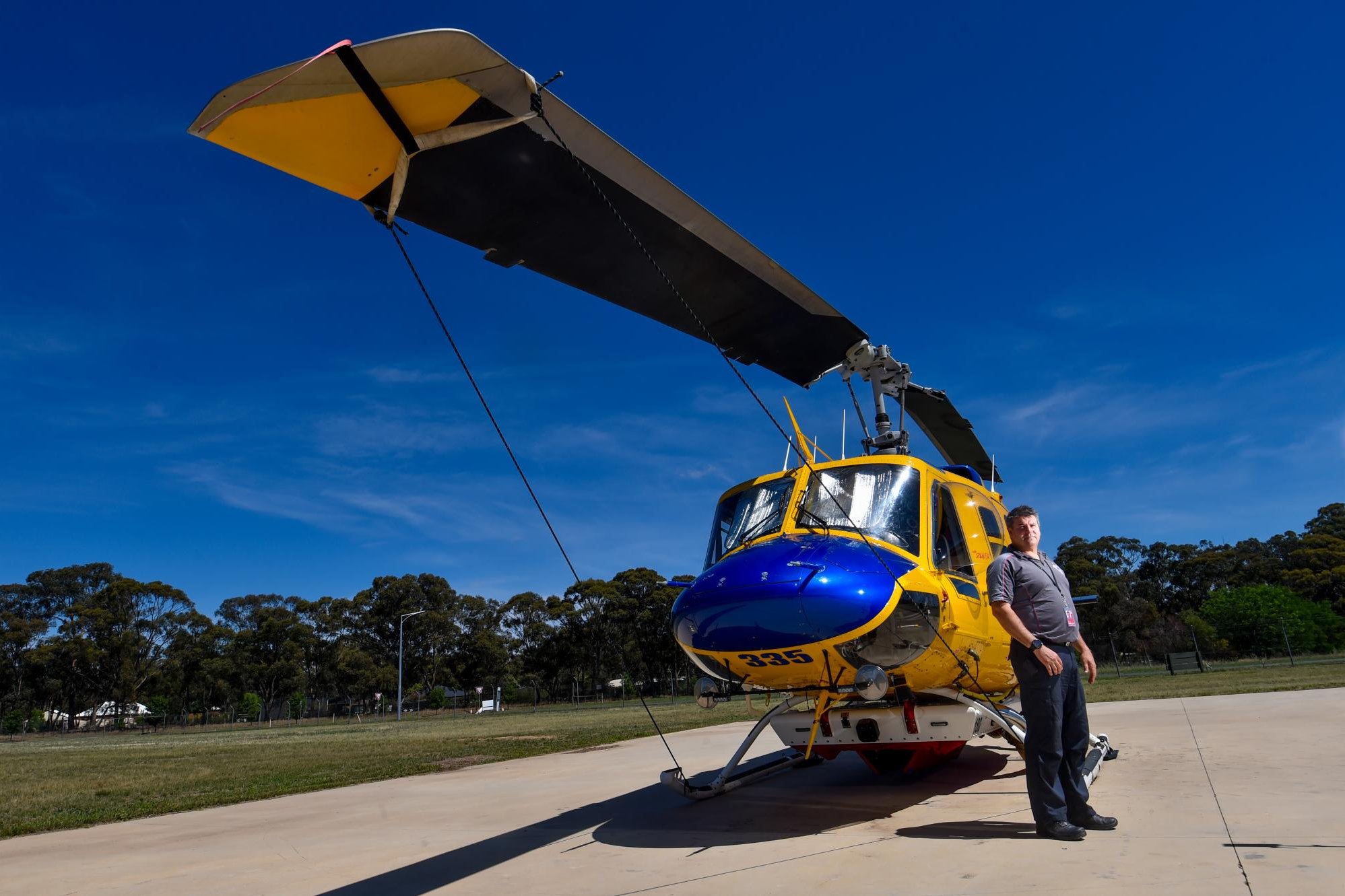 Luke Waterson in front of the Helitak 335 waterbomber. Picture by Darren Howe