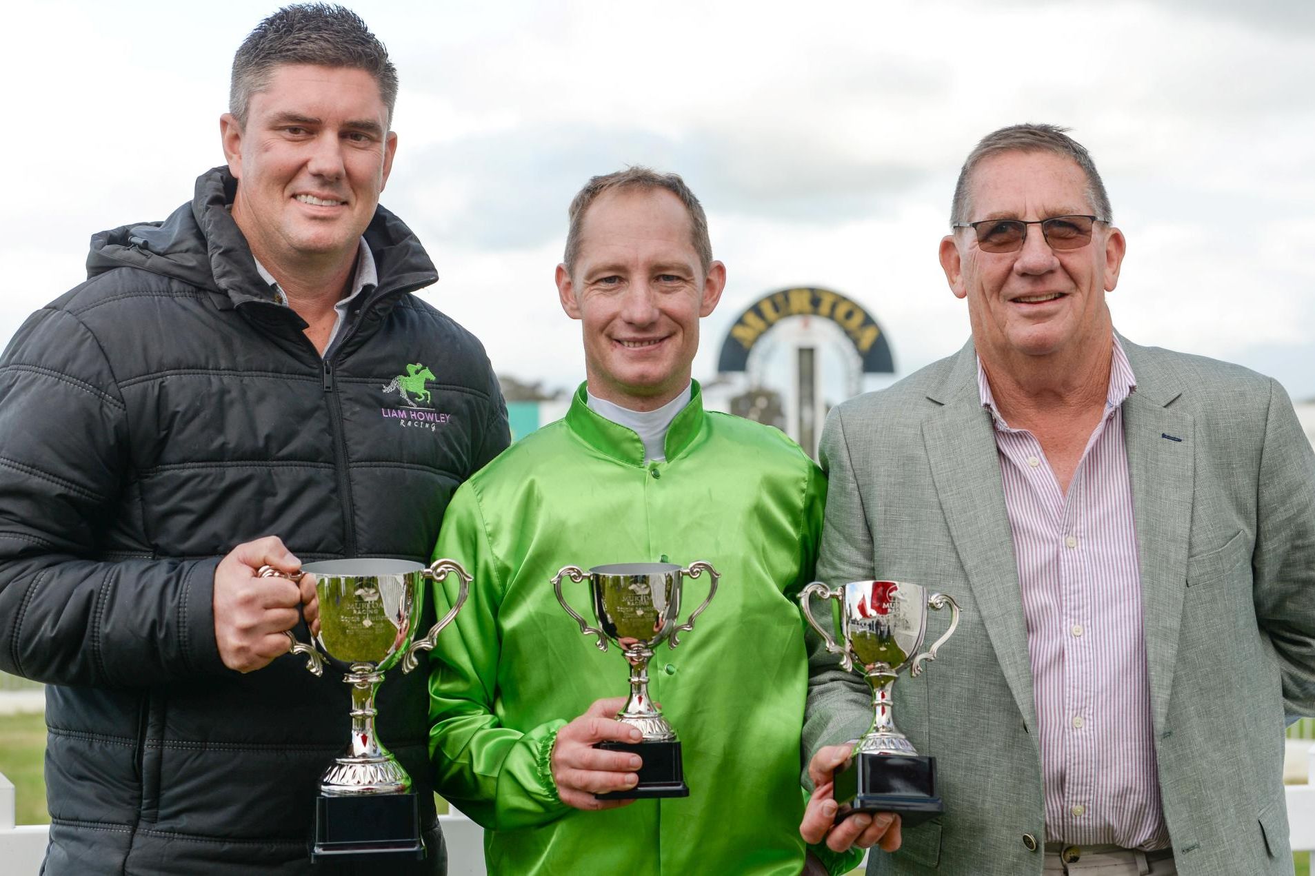 Stawell jockey Jack Hill, middle, is all smiles after riding Station One of victory in the 2023 Murtoa Cup on Saturday, October 5. Picture by Ross Holburt/Racing Photos