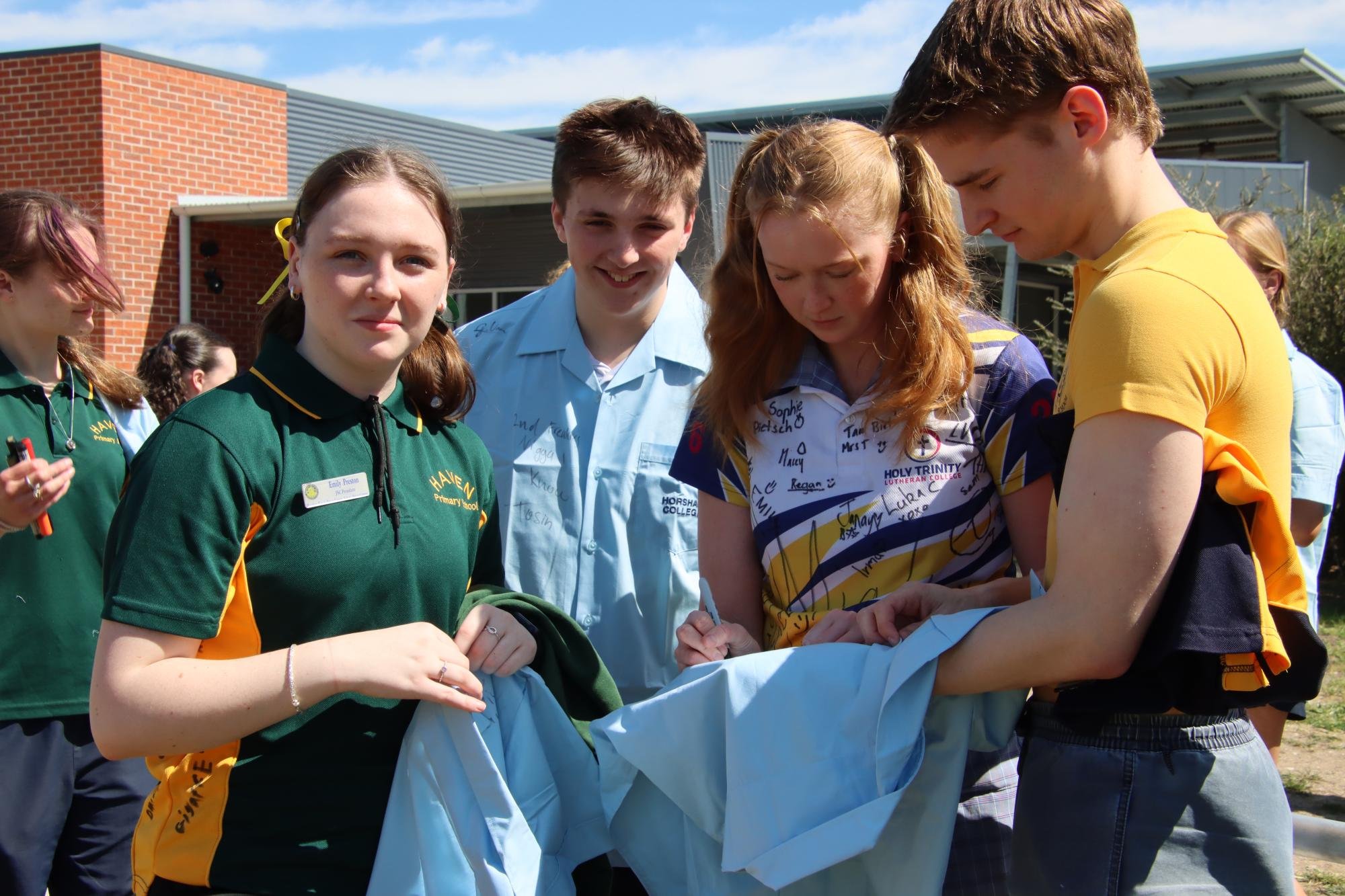[Right] Adding a signature to a mate's shirt is customary.