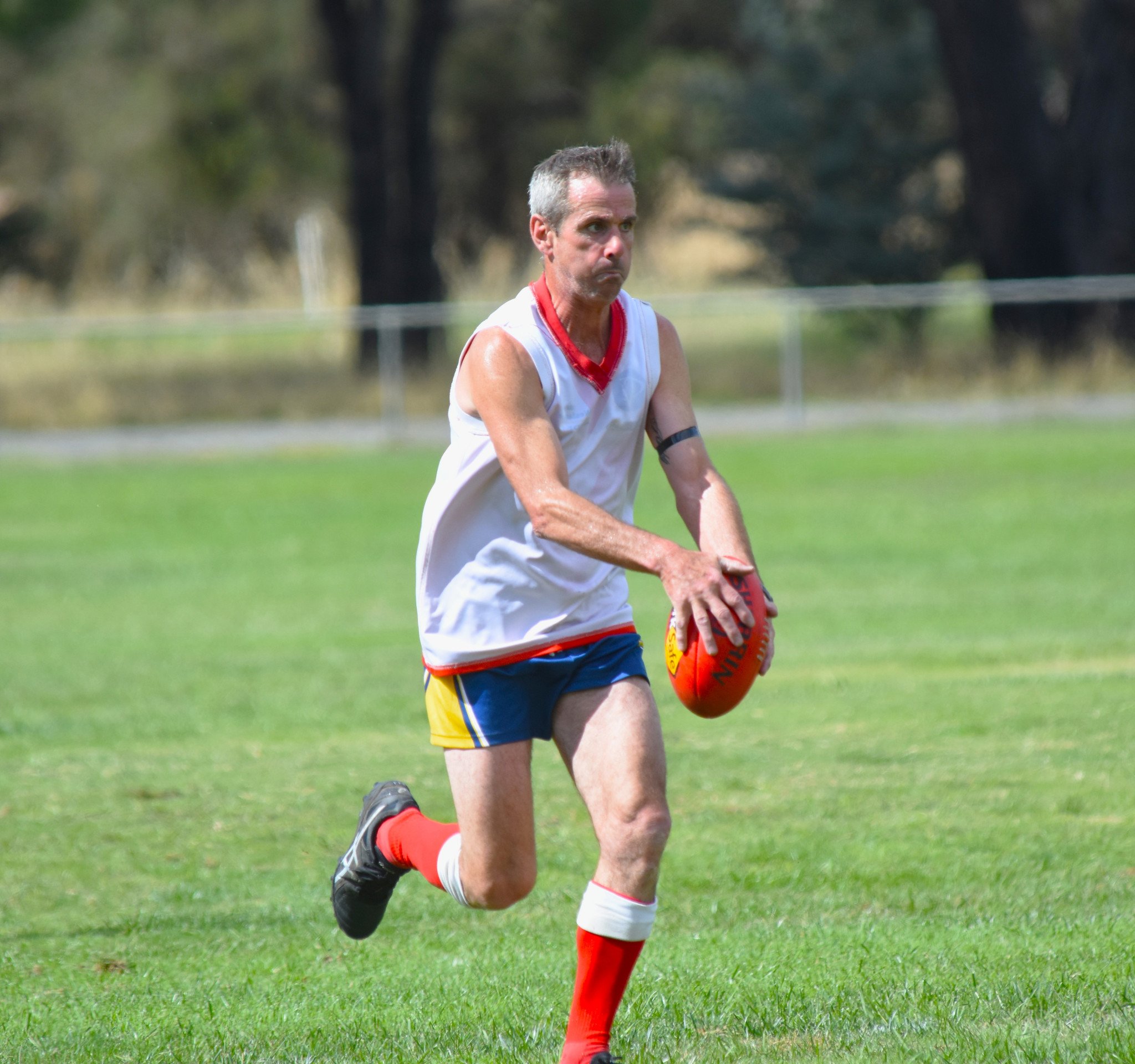 Mark Hallam looks at his options upfield.