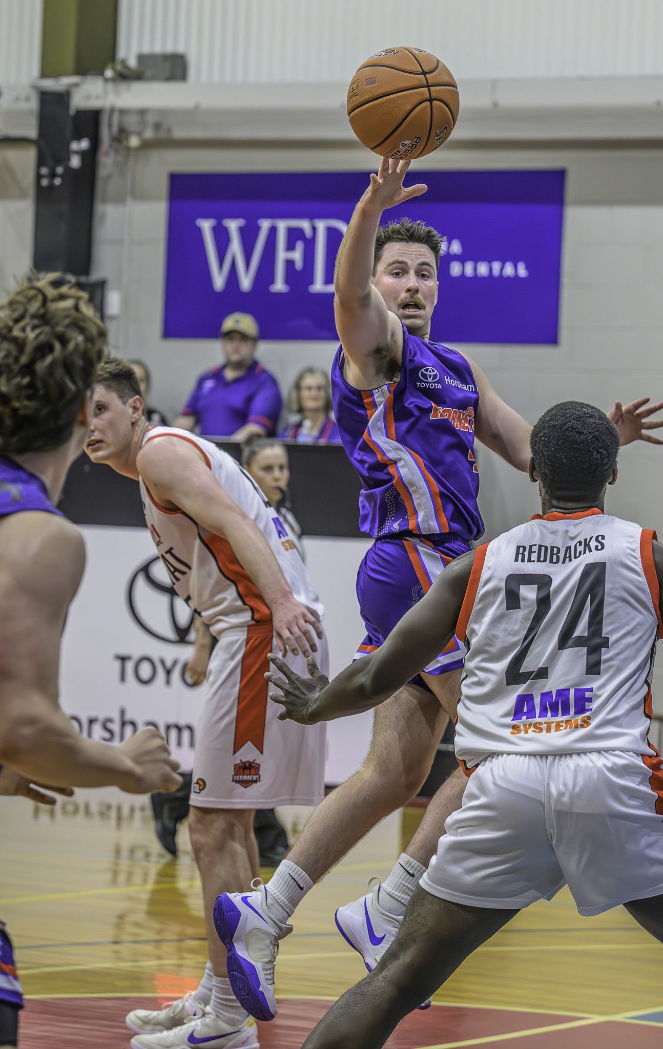 Hornets captain Mitch Martin sends a pass over an Ararat defender to Micah Livingstone.