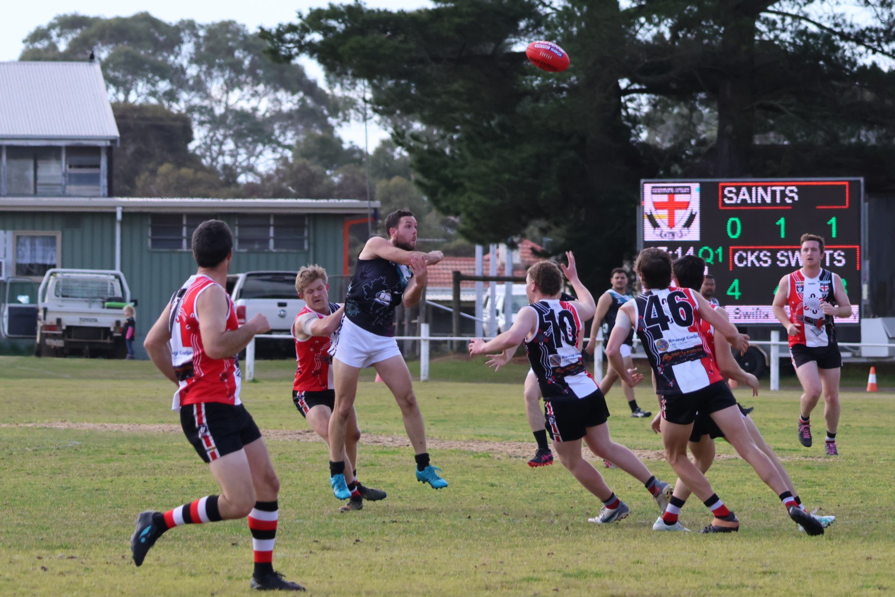 Swifts' Scott Carey gets a handball away.
