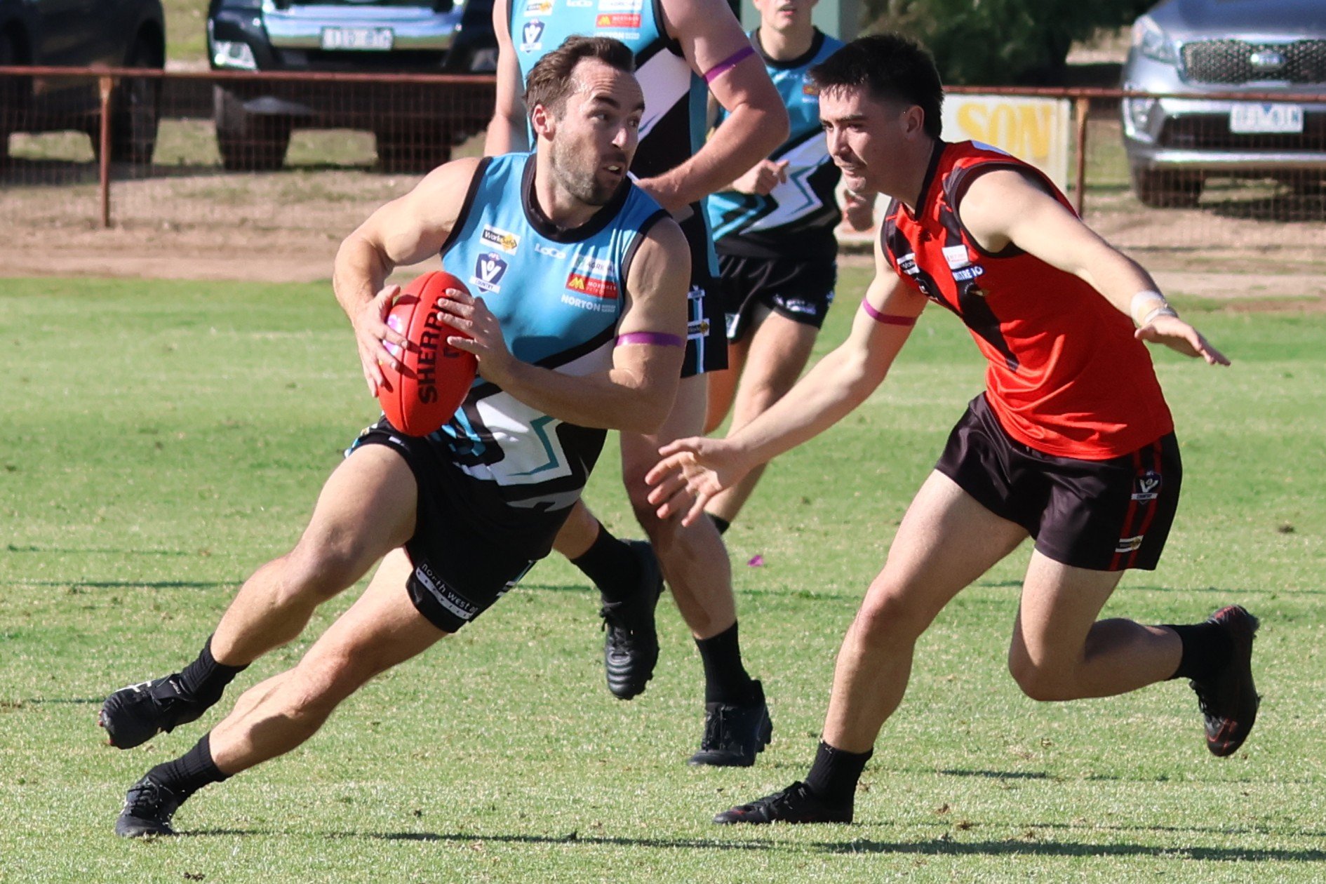 Rupert Sangster looks to send the ball forward.
