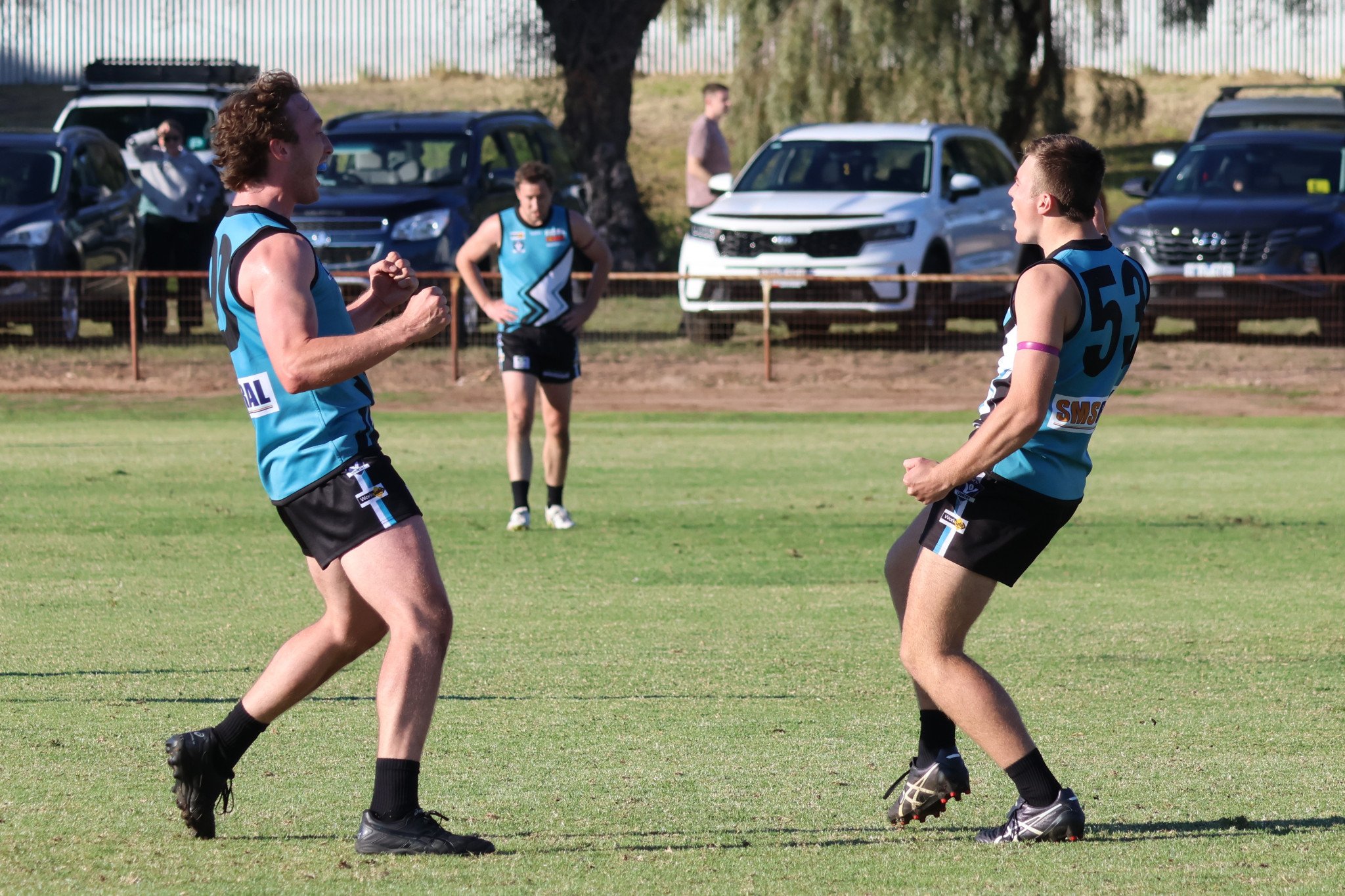 Harry McLeod and Jackson Moore celebrate Moore's second goal for the game.