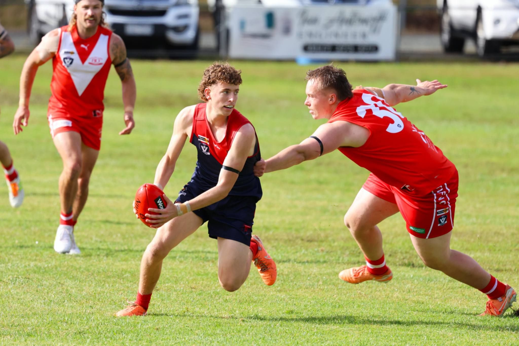 Laharum's Monty Wynne attempts to evade Logan Millar. In what was a tight contest for the majority of the game, the Demons defeated Taylors Lake 12.15 (87) to 8.2 (50).
