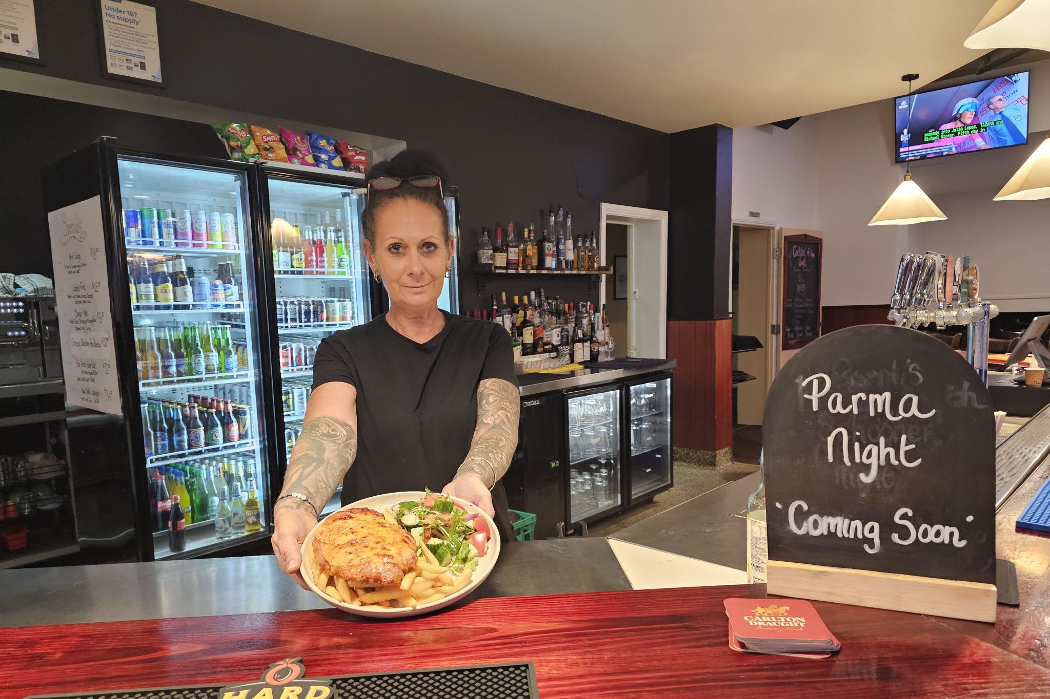 Creekside Hotel staff member Jacquelyn Devlyn pictured with the 'Best Parma of the Year' at the pub.