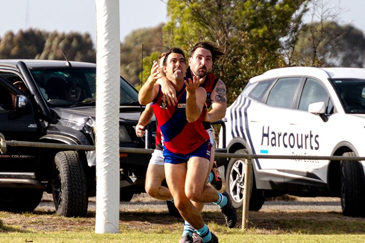 Justin Williams looks to mark while being defended by Dyson Parish