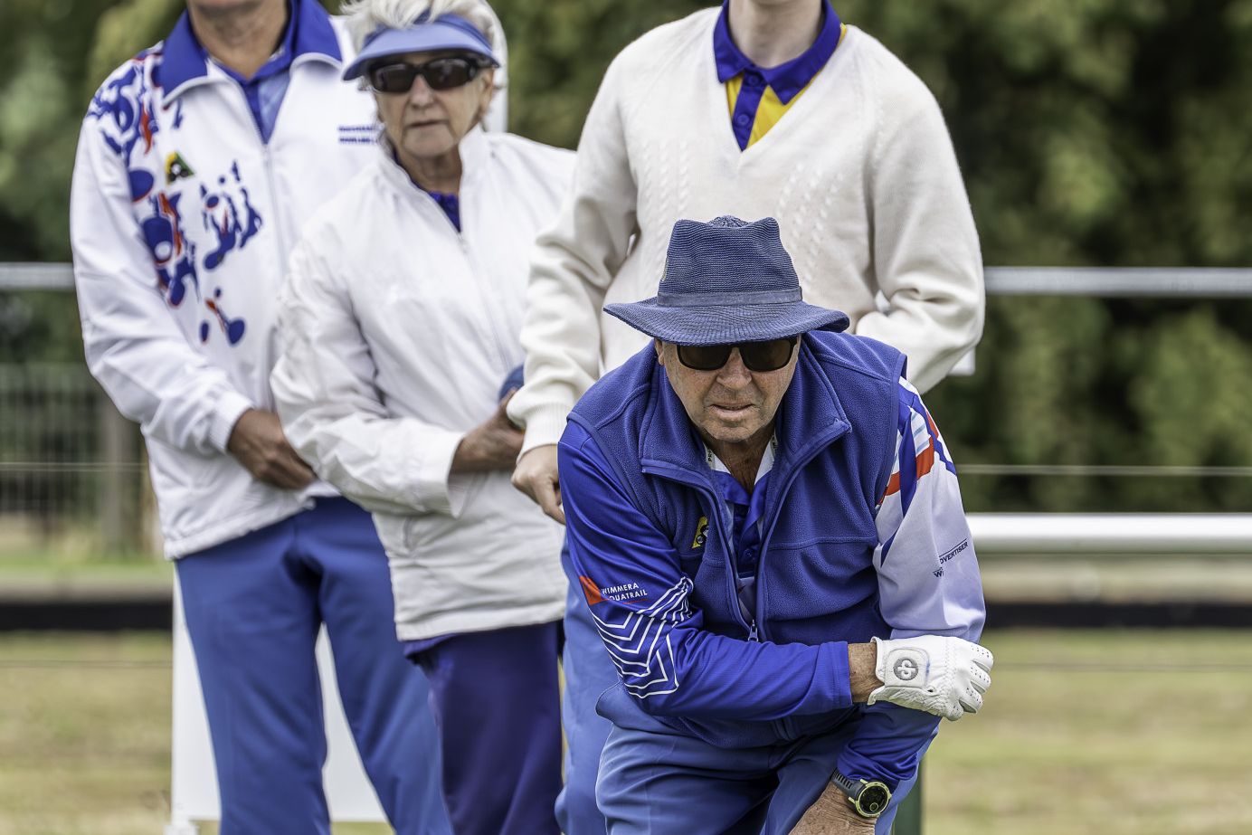 Horsham City lead Doug Mitchell has a small crowd watching his bowl.