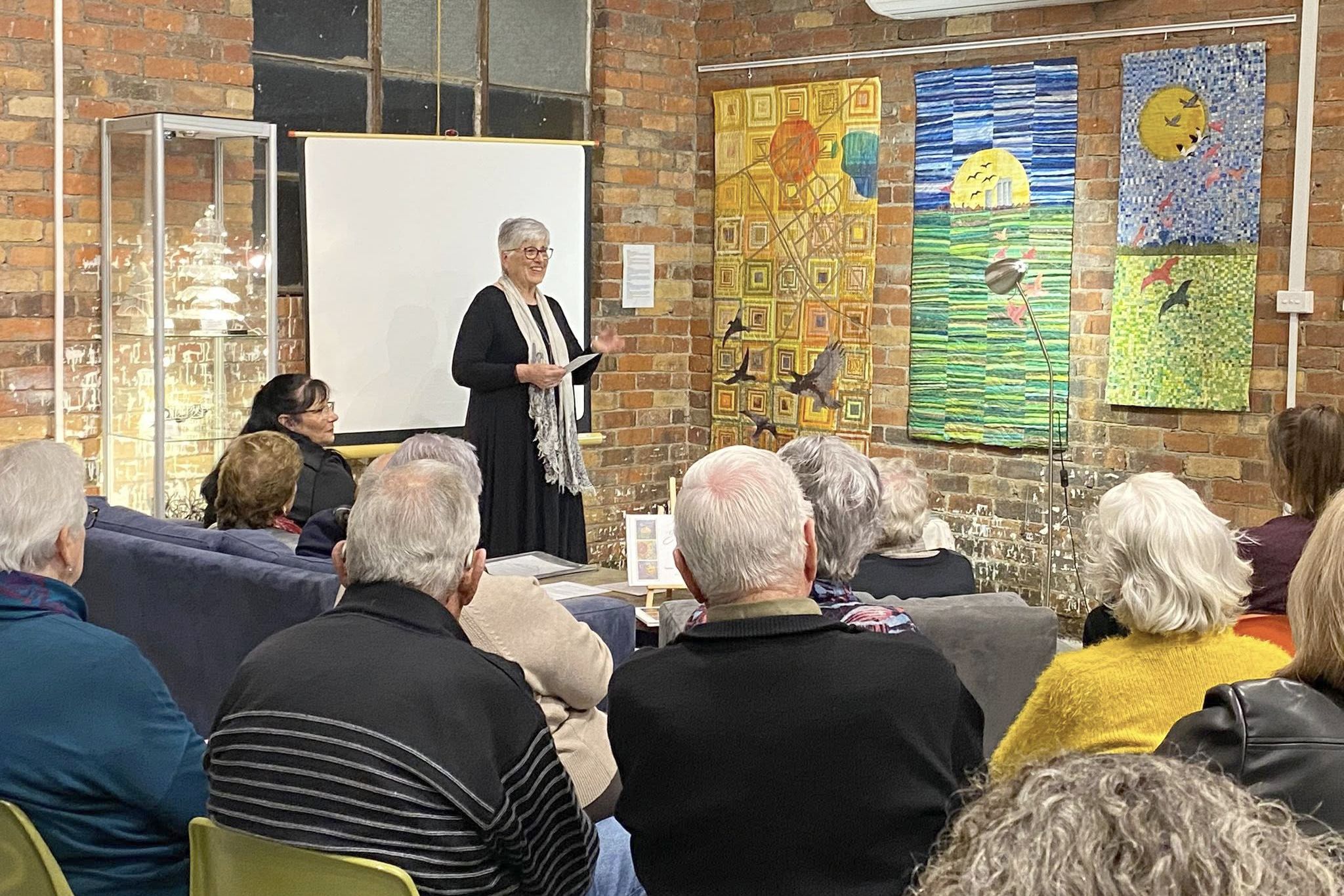 Local artist Nina Gould speaks on how she designed the three banners displayed, making a series of drawings of rural viewpoints inspired by photographs and reference books.