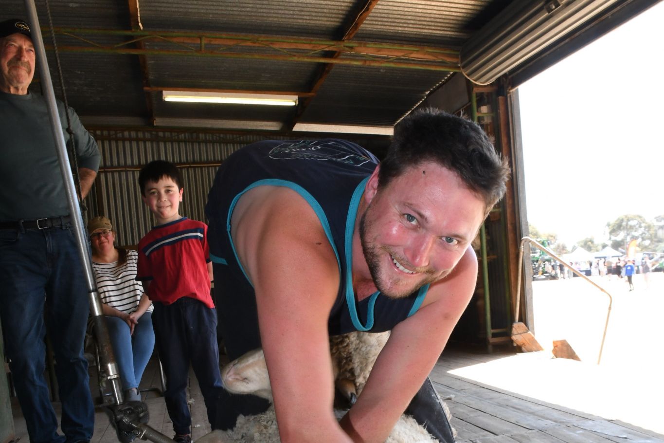 Matt Arnott give a shearing demonstration at the show to his family including his sister who had just arrived from overseas after some years.