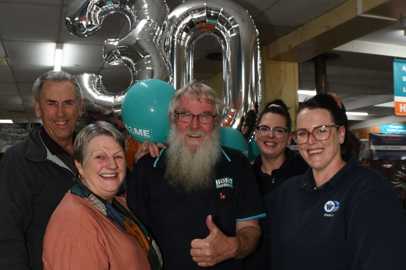 Warracknabeal Home Hardware proprietors Richard and Joy Wilken, left, together with daughters Kathryn and Emma congratulate long standing team member Colin Newell on his 30 years of service.