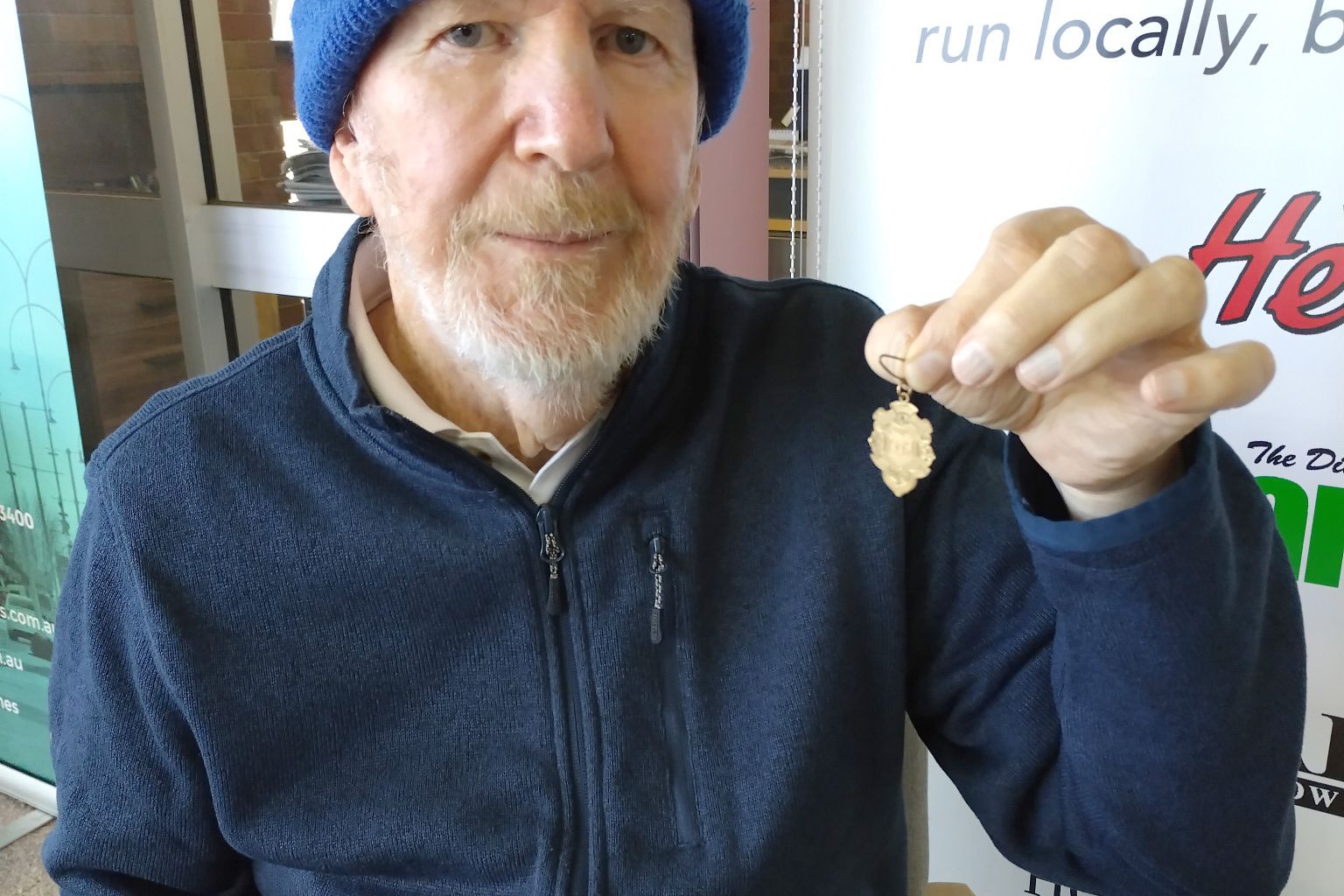 Frank Bretag holds his father's 1936 Ellam Football Club premiership medal.
