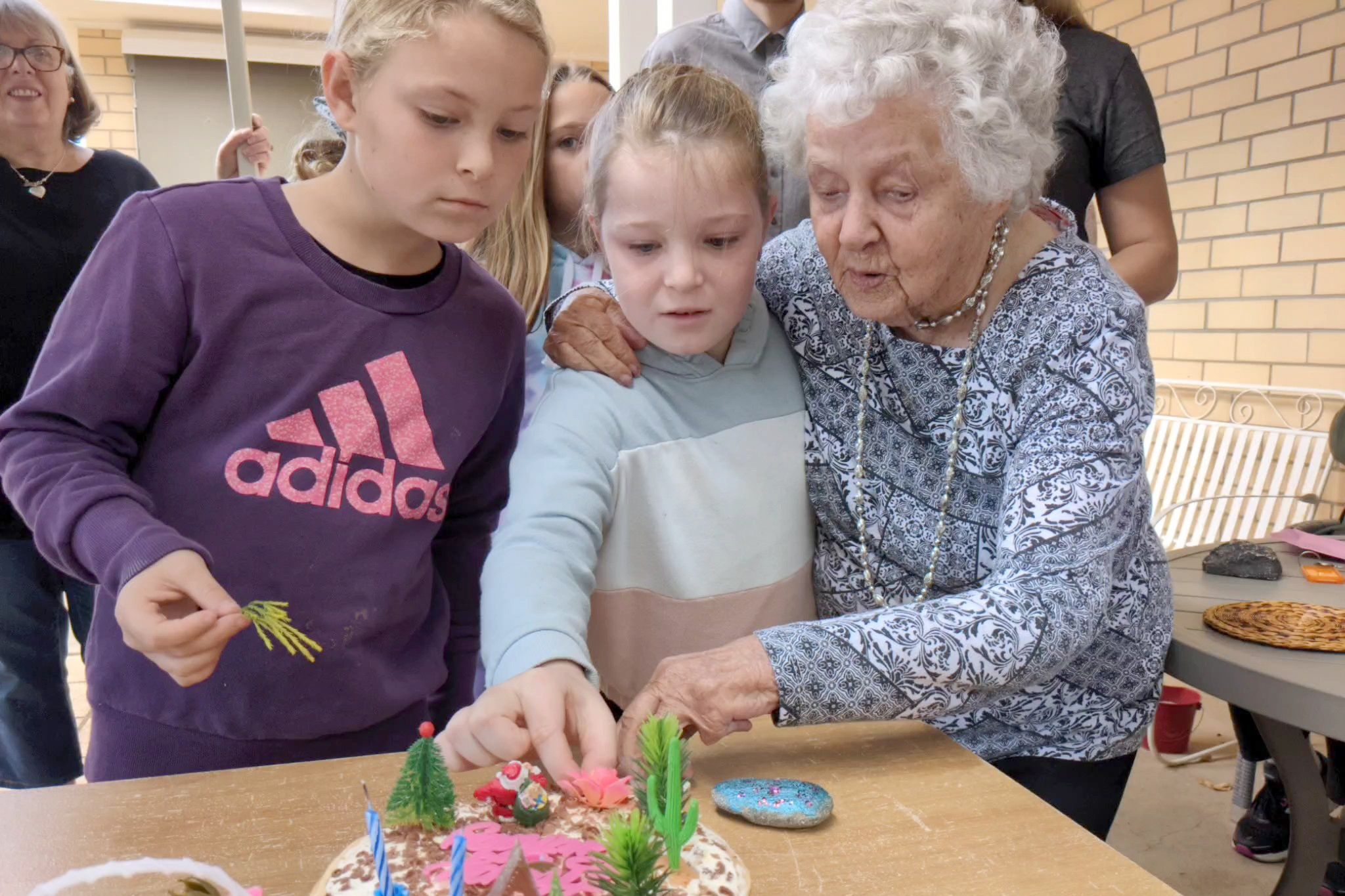 Vera Woods is about to light the candles on her 96th birthday cake with the help from two of her great-granddaughters.