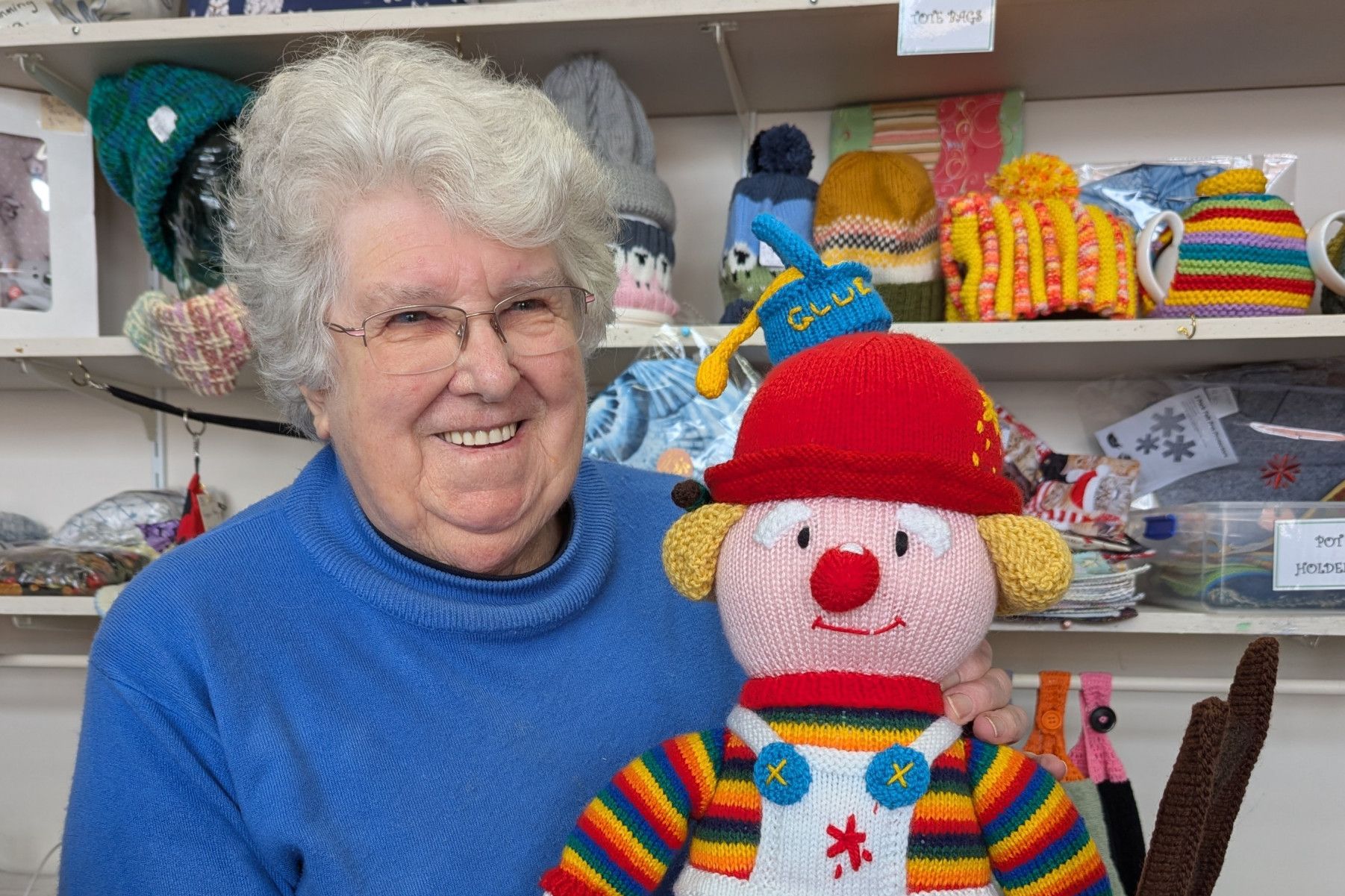 Marion Smith holds the colourful knitted clown as Craft for a Cause searches for its original owner. Photo credit: NATALIE ANDERSON
