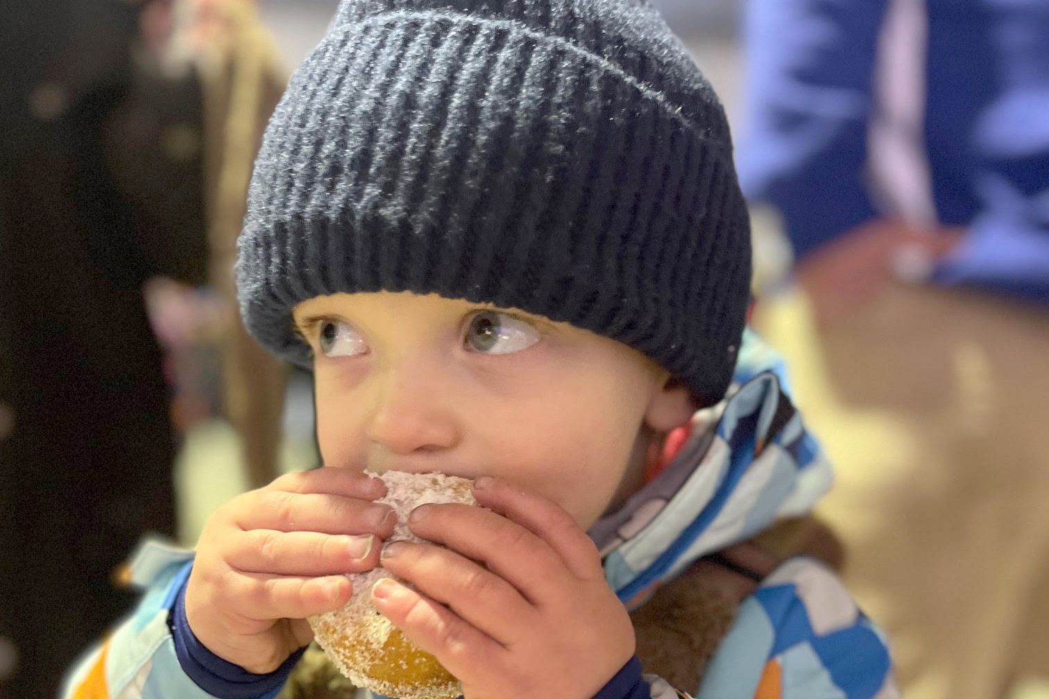 Two-year-old Leyton Hay enjoys a hot jam donut - just one of the goodies on offer at last weekend's Christmas in July market.