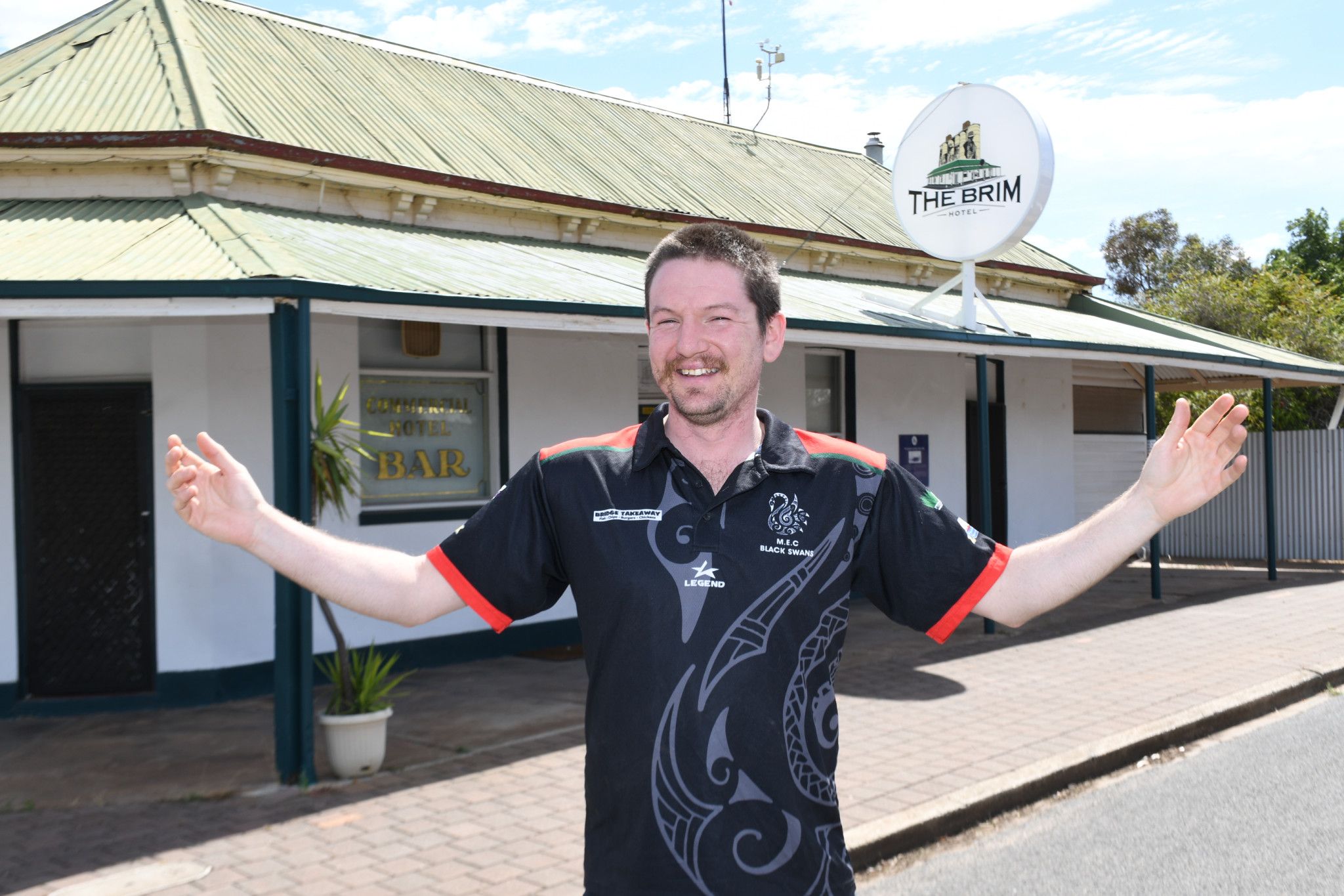 New co-owner Connor Woods stands happily outside Brim Hotel ahead of its reopening on December 12.