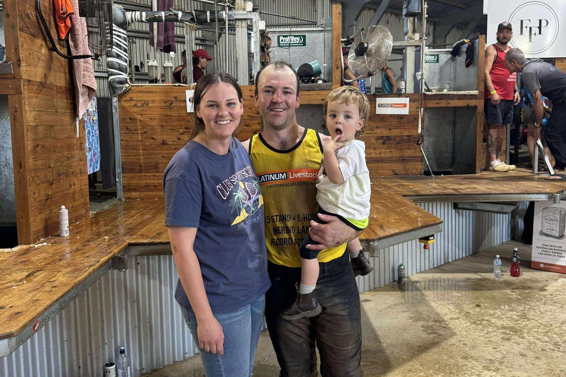 After being part of the five-stand, eight-hour world record, Dimboola Shearer, Nick Lehmann stands with partner, Liv Maloney and 20-month-old son, Paddy. Liv was his official masseuse/physio for the day.