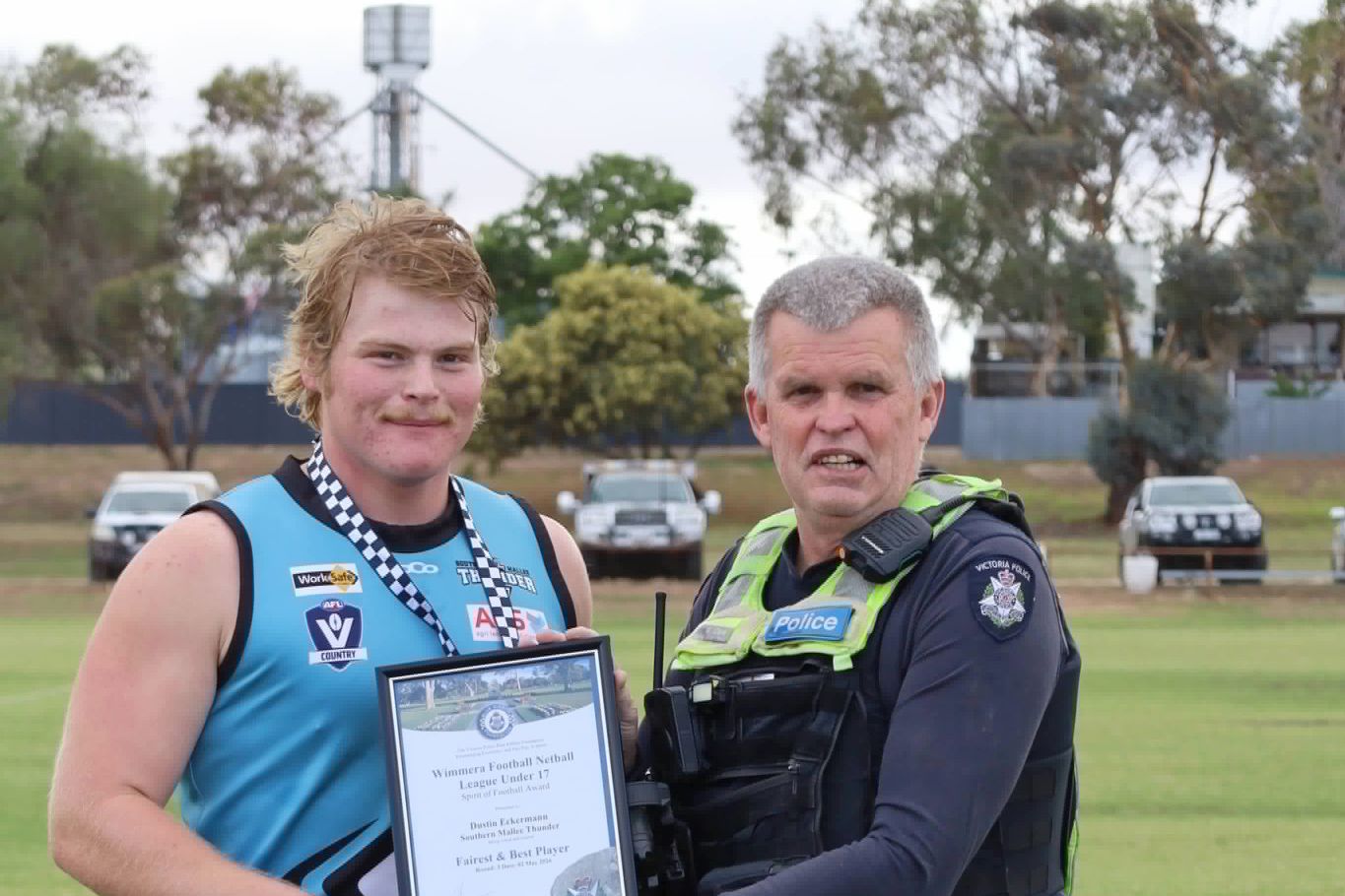 Southern Mallee Thunder footballer Dustin Eckermann with Leading Senior Constable Tony Clark.