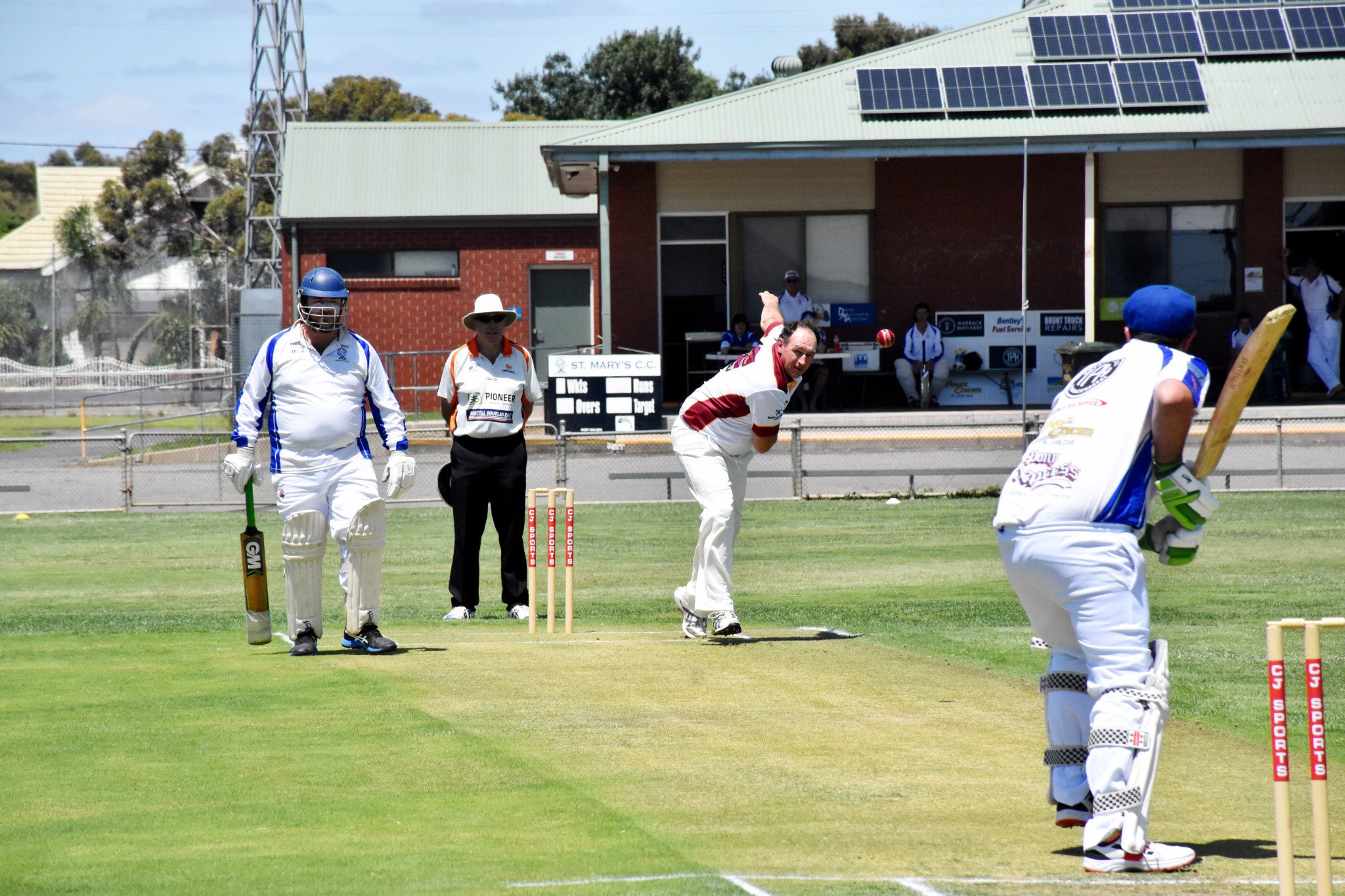Tim Bell bowling to Colby Schmidt with Nicholas Germano at the non strikers end.