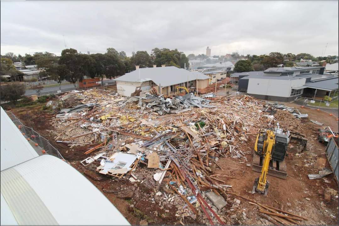 The roof of the multipurpose/cooking rooms can be seen in the bottom left corner of this photo which shows the heritage buildings that will become part of the new facilities, and the 'junior' classrooms, amongst the rubble of the old senior library and administration blocks.