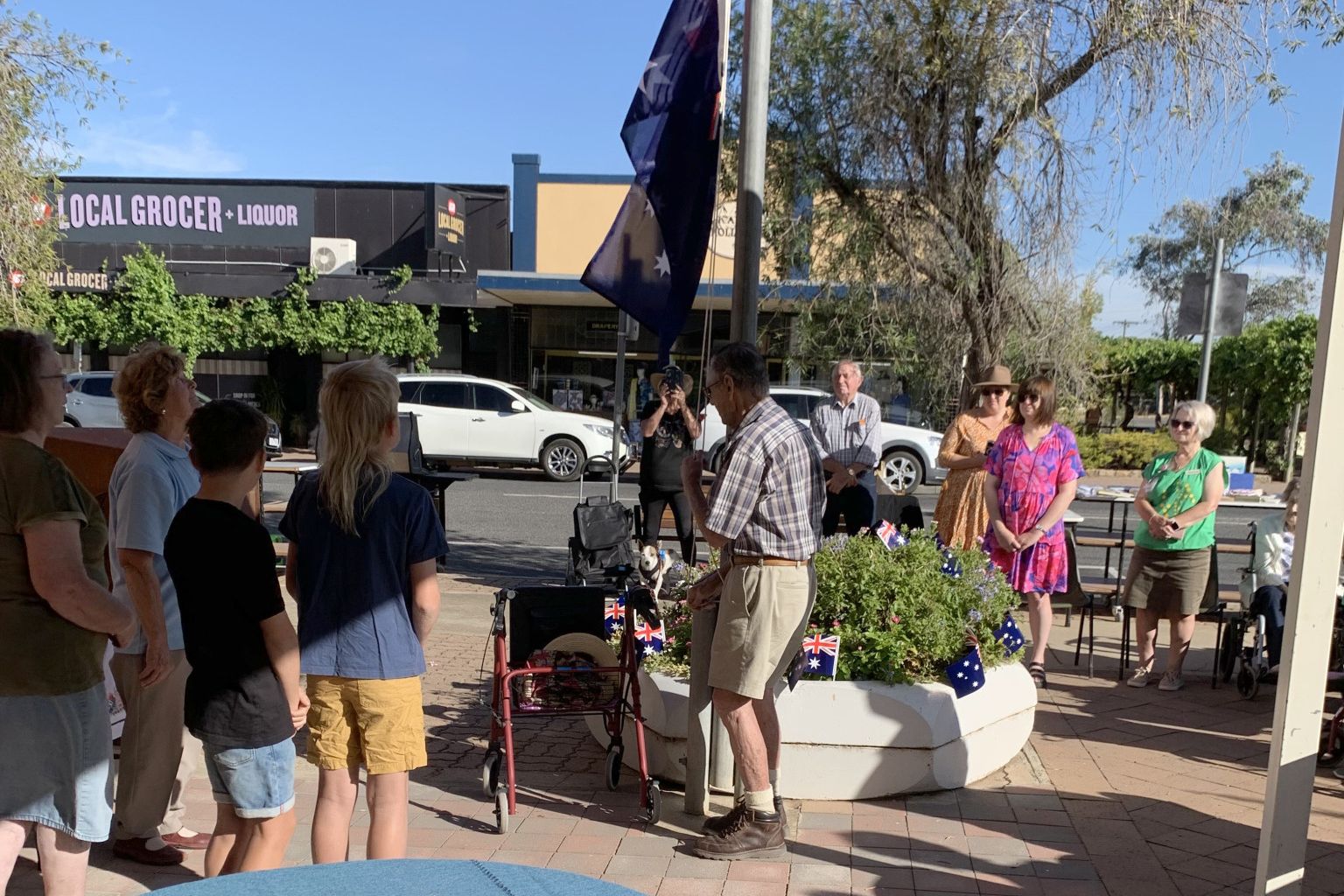 Ex-Scout master Wilf Webster raises the flag at Australia Day 2025 breakfast celebrations.