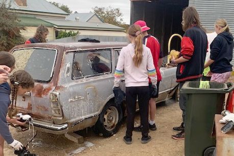 Rainbow P-12 College students start work on the 1974 Toyota Cressida.