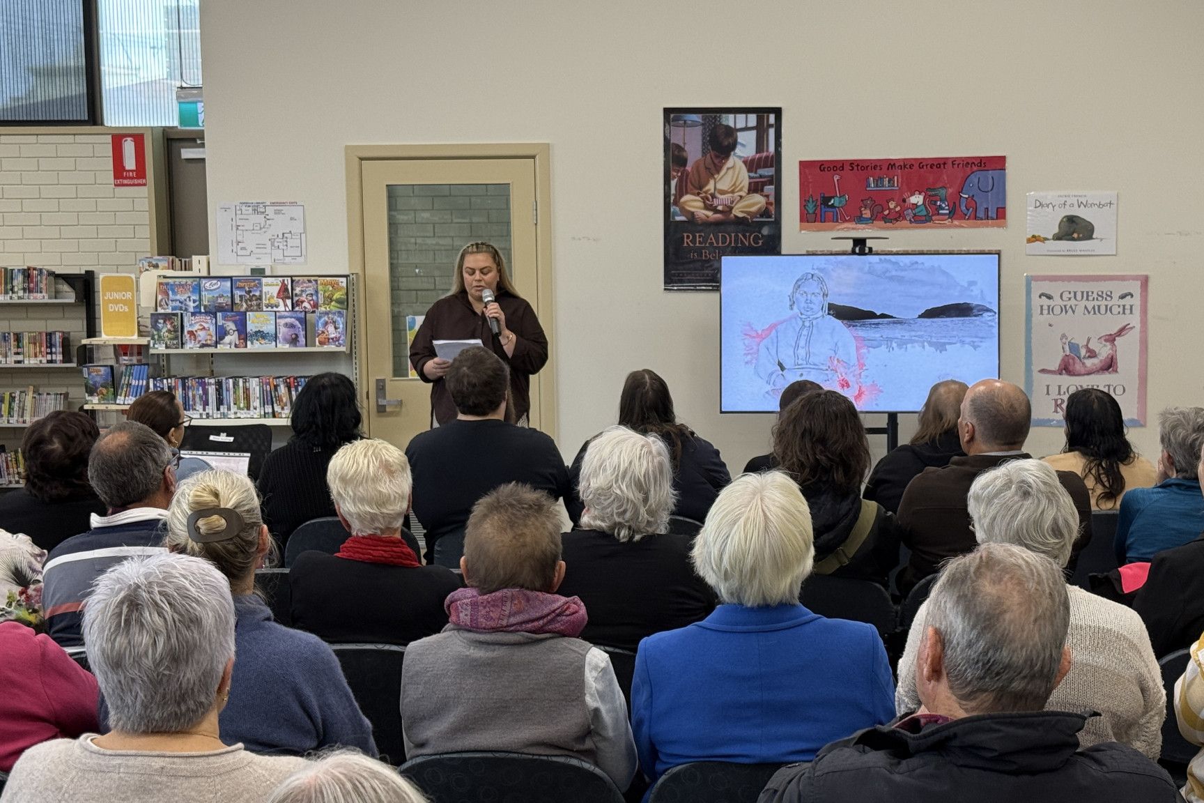 Olivia Huebner, niece of late Dr Sharon, shares her thoughts with the packed audience.
