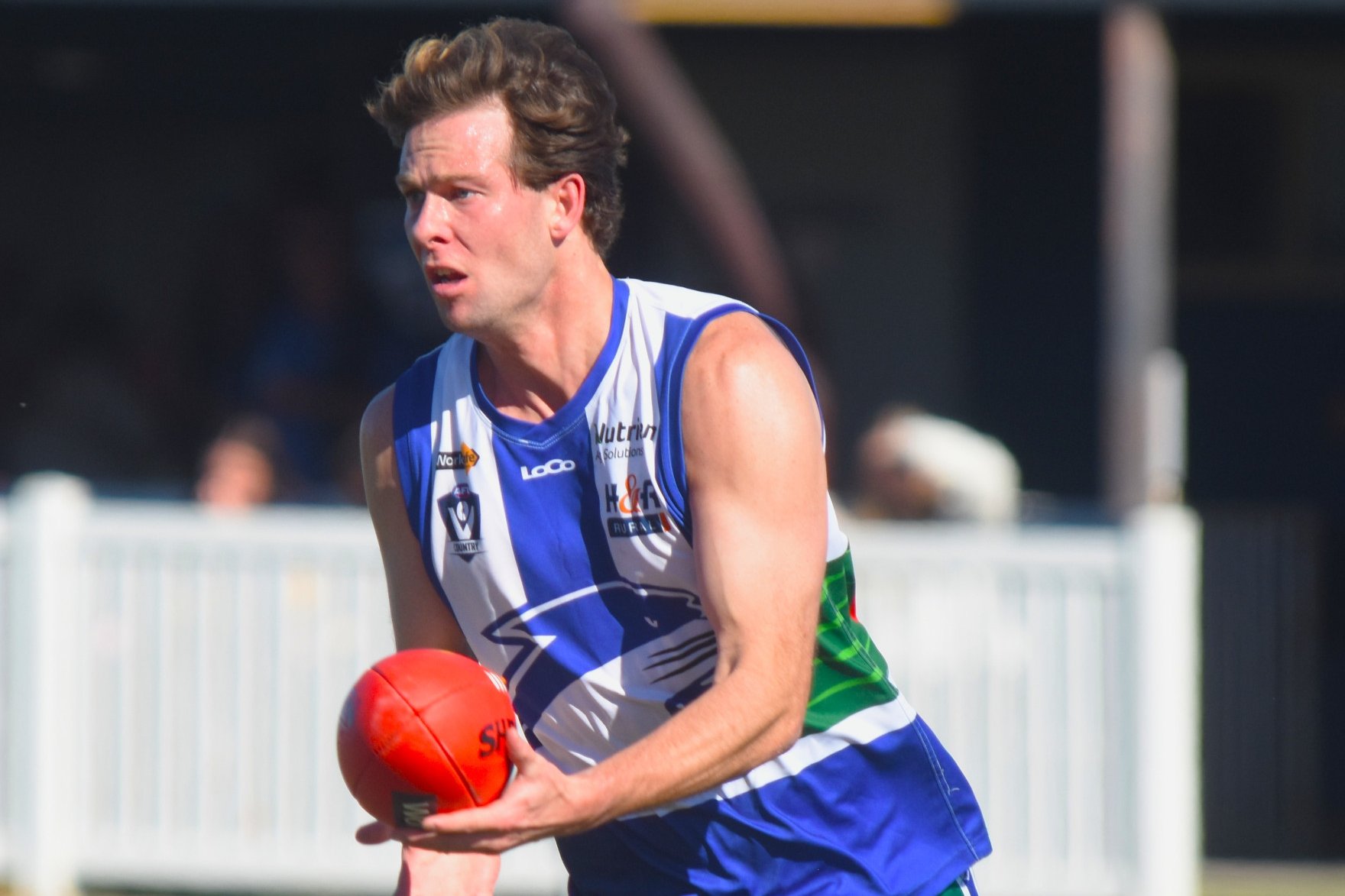 Josh Clayton prepares to handball against Natimuk United. The Cougars defeated the Rams 115-98 in a competitive affair.