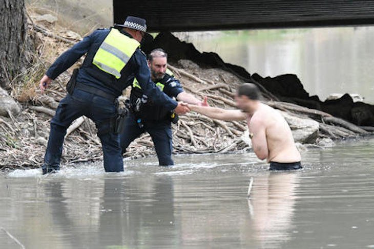 Leading Senior Constables Michael Baldock and Prit Thandi assist the alleged thief from the Yarriambiack Creek after an extensive pursuit for over a kilometre in the creek late Saturday afternoon.