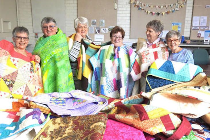 Horsham Patchwork Quilters members Sally Lockwood, Pauline Lentsment, Faye Cameron, Jane Bolwell, Pam Langlands and Lea Crammond show some of the quilts made for palliative-care patients.