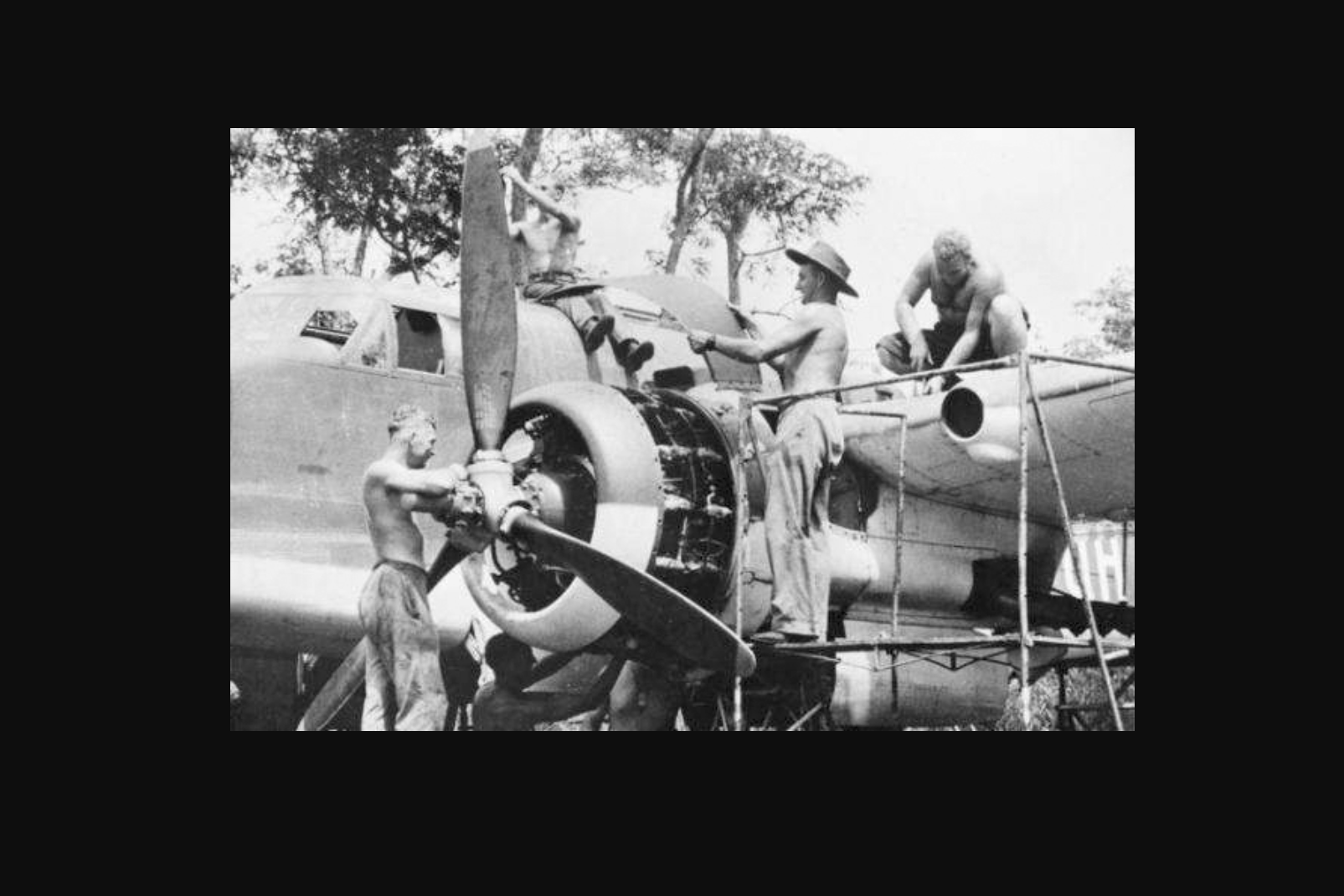 RAAF fitters work on a plane at an Australian airfield.
