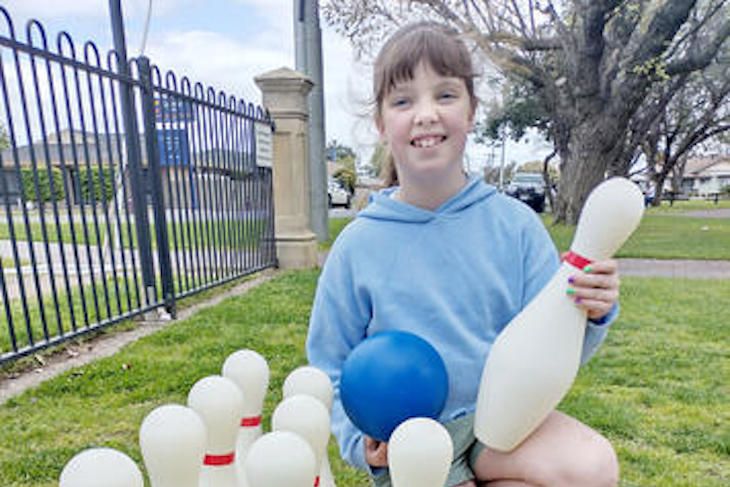 Isla Stacey has a go as ten pin bowling in May Park, Horsham. Photo: FAYE SMITH