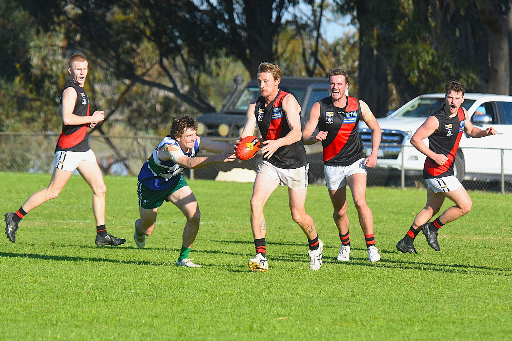 Noradjuha Quantong's Thomas Phyland looks to get the kick away while being pursued by Kaniva Leeor's Billy King. The Bombers came away with an 8.16 (64) to 6.8 (44) victory in the round 11 clash.