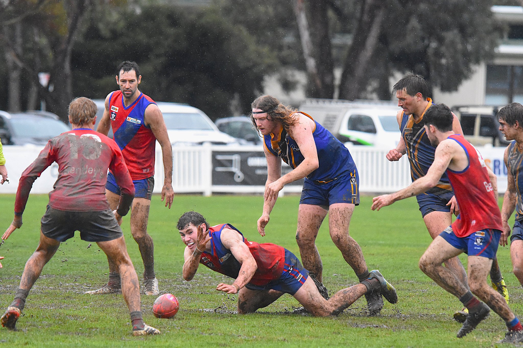 Kalkee's Will Drummond attempts to flick the ball to a teammate during his side's muddy and wet round-nine clash with Natimuk United. The Kees prevailed 7.10 (52) to 4.5 (29) for their fifth win of the year.