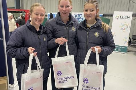 Year 10 Horsham College students Ella Hallam, Phoebe Sudholz and Lexy Wade collect goodies from displays. Photo: CAITLIN MENADUE